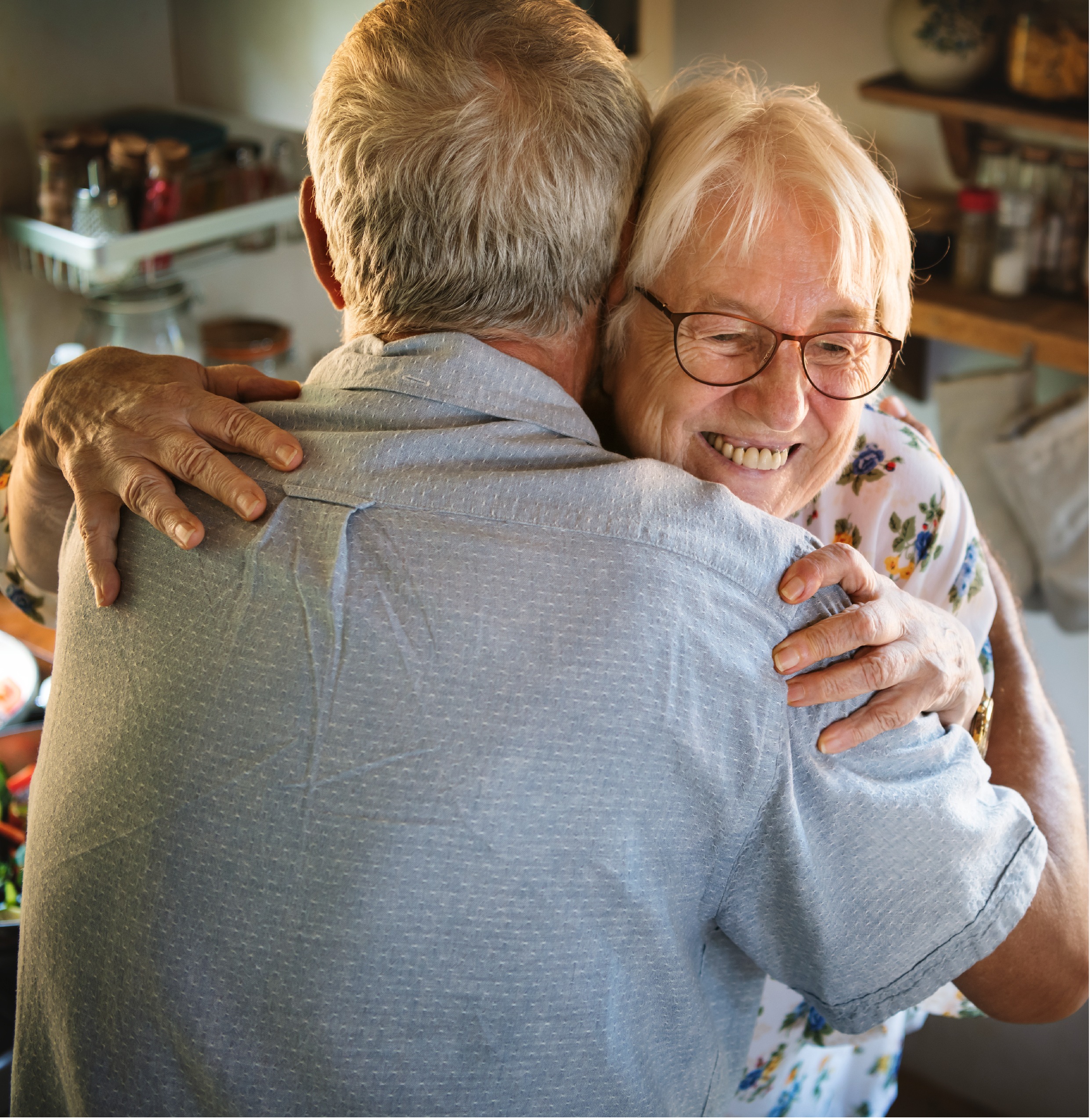 Senior family caregiver couple embracing